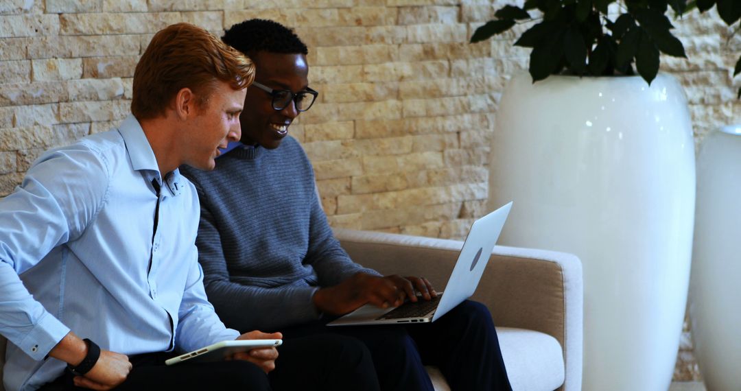 Diverse Business Team Collaborating with Laptop Technology