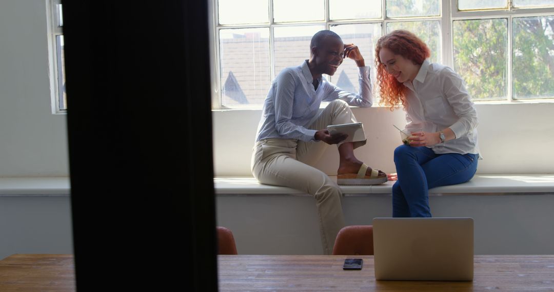 Young Diverse Colleagues Collaborating in Bright Office
