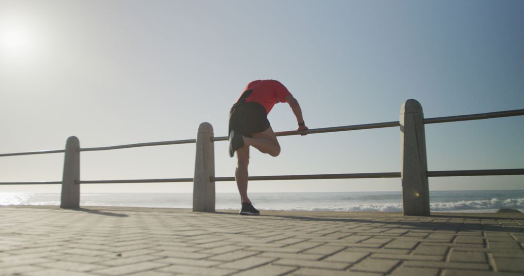 Male Athlete Stretching by Ocean at Sunrise - Free Images, Stock Photos and Pictures on Pikwizard.com