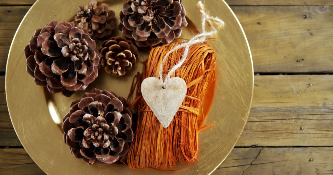 Rustic Table Arrangement with Pinecones and Heart Ornament - Free Images, Stock Photos and Pictures on Pikwizard.com