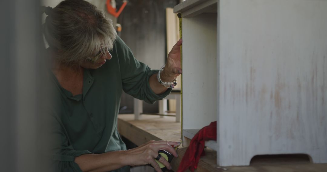 Woman measuring wooden furniture using tape measure - Free Images, Stock Photos and Pictures on Pikwizard.com