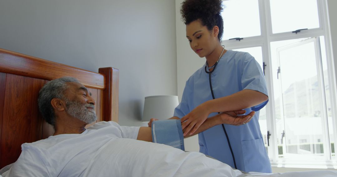 Nurse Checking Blood Pressure of Senior Man in Hospital Room - Free Images, Stock Photos and Pictures on Pikwizard.com