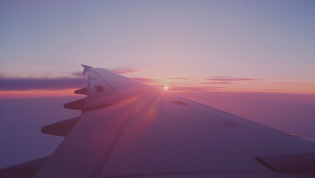 Airplane Wing and Beautiful Dawn Horizon from Window View