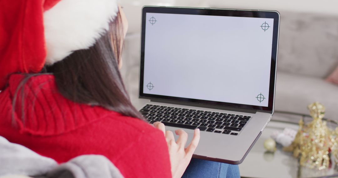 Woman in Santa Hat Using Laptop for Christmas Shopping - Free Images, Stock Photos and Pictures on Pikwizard.com