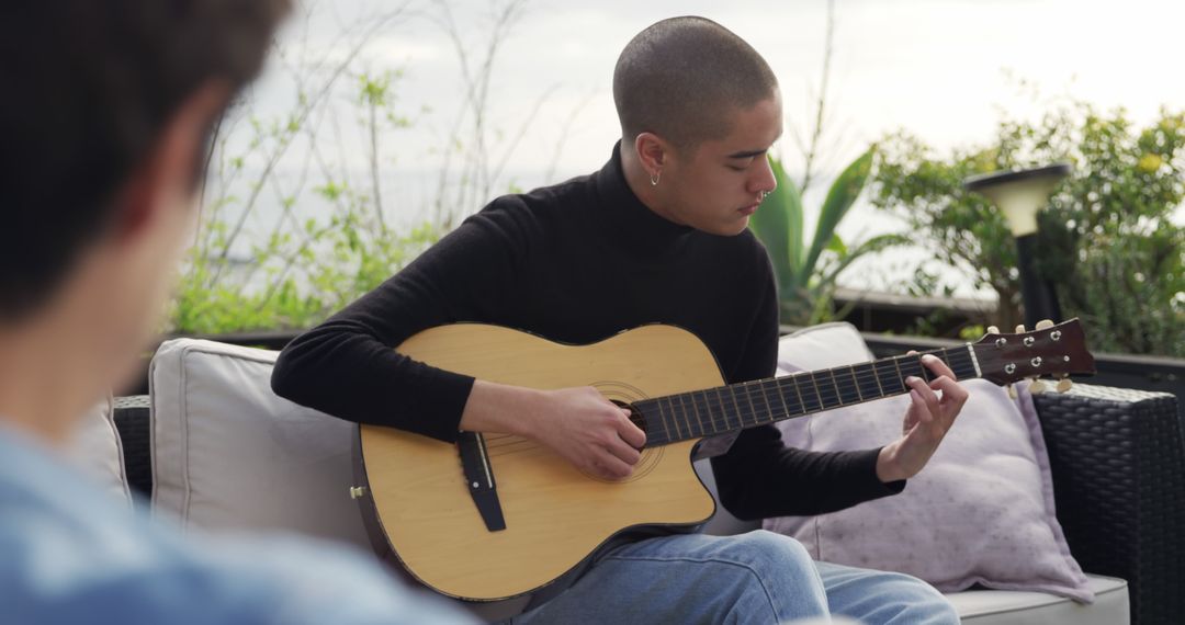 Young Adult Playing Acoustic Guitar Outdoors - Free Images, Stock Photos and Pictures on Pikwizard.com