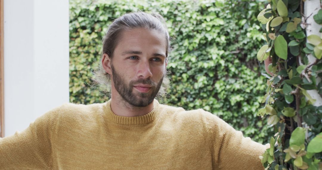 Man Relaxing in Garden Wearing Yellow Sweater Outdoors - Free Images, Stock Photos and Pictures on Pikwizard.com