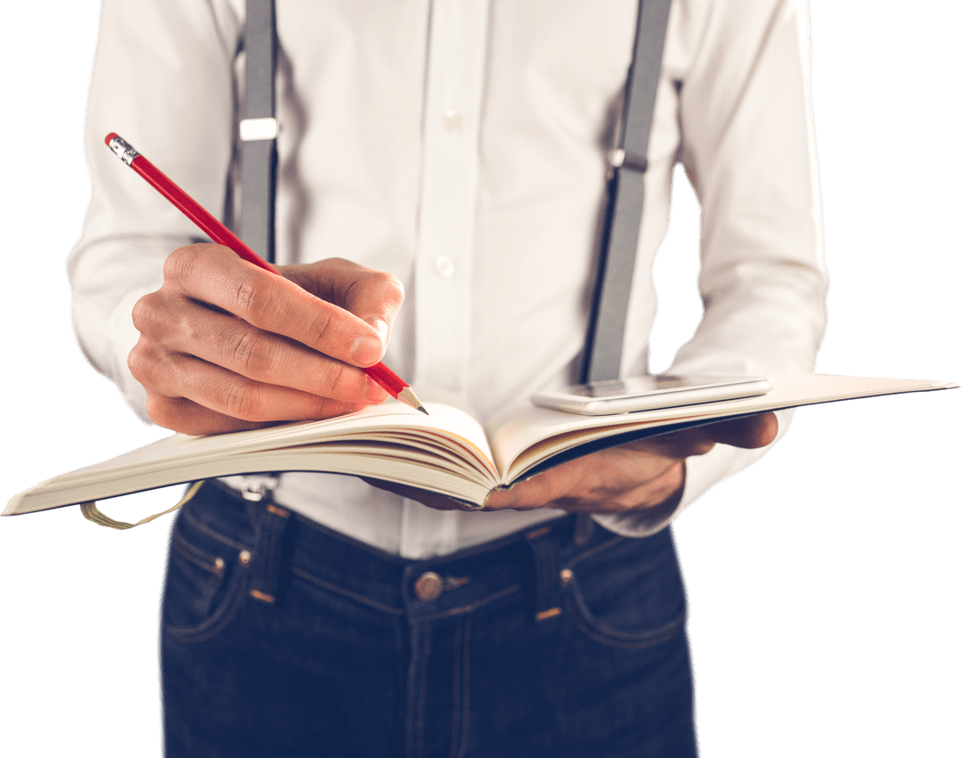 Man Wearing Suspenders Writing in Notebook with Smartphone