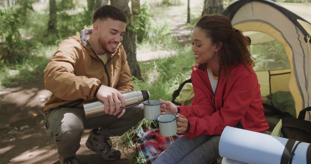 Couple Enjoying Camping Coffee Break in Forest