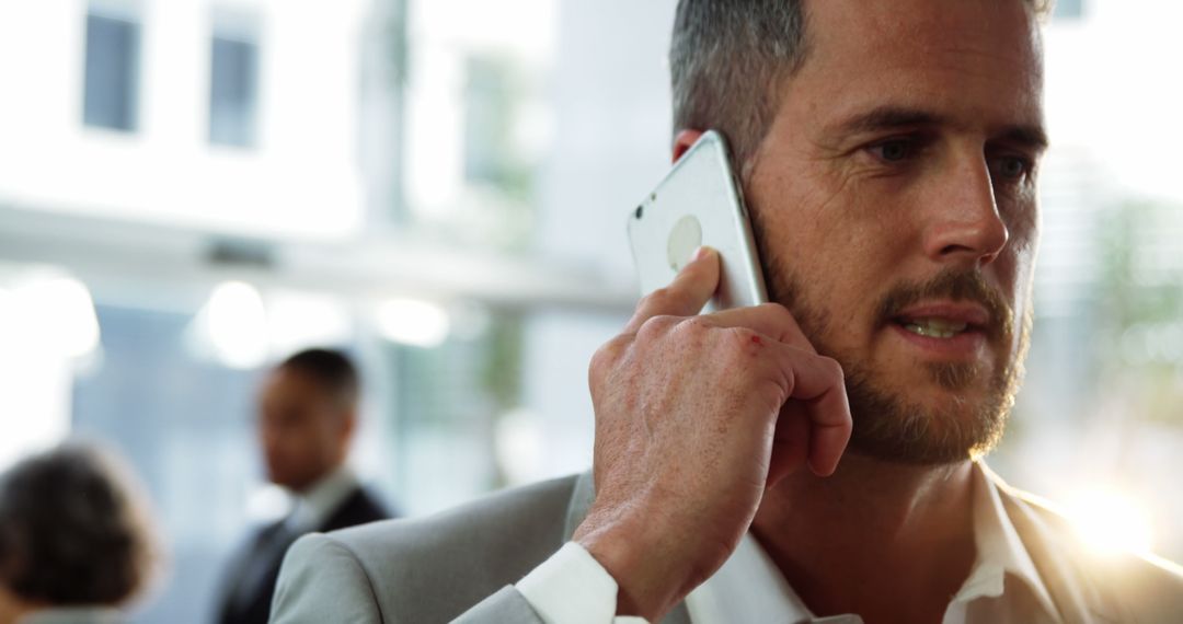 Businessman Taking Phone Call in Modern Office - Free Images, Stock Photos and Pictures on Pikwizard.com