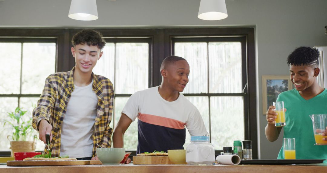 Diverse Teenage Boys Cooking and Enjoying Beverages Together in Kitchen - Free Images, Stock Photos and Pictures on Pikwizard.com