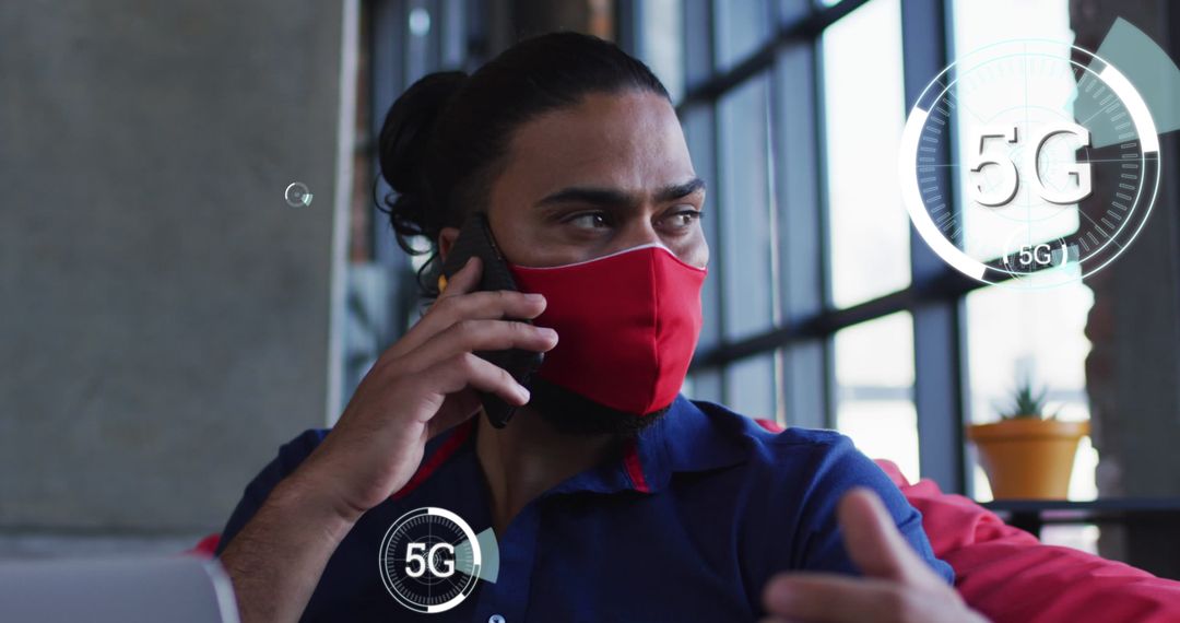 Biracial Man Using 5G Technology While Wearing Mask in Modern Cafe