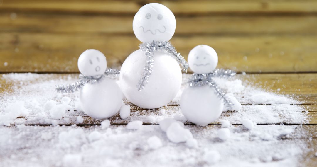 Creative Snowman Family on Wooden Background - Free Images, Stock Photos and Pictures on Pikwizard.com