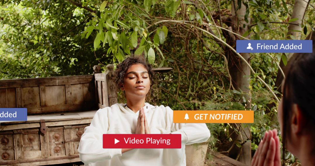 Young woman meditating outdoors in hoodie with rustic chest and social media overlays