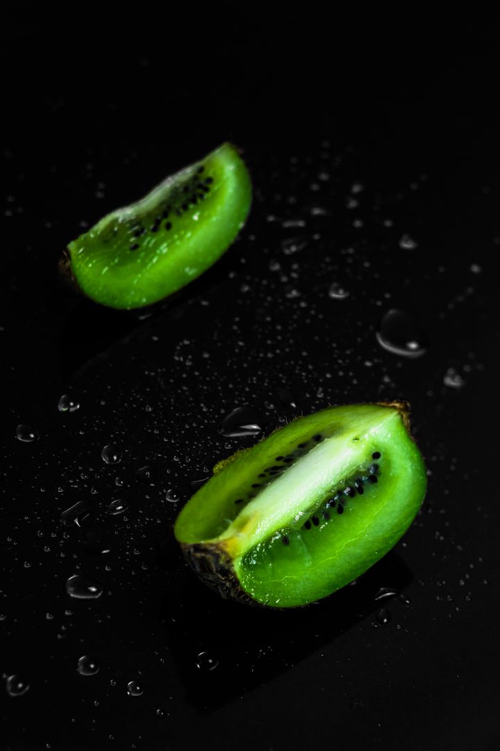 Fresh Kiwi Slices on Black Surface with Water Droplets - Free Images, Stock Photos and Pictures on Pikwizard.com