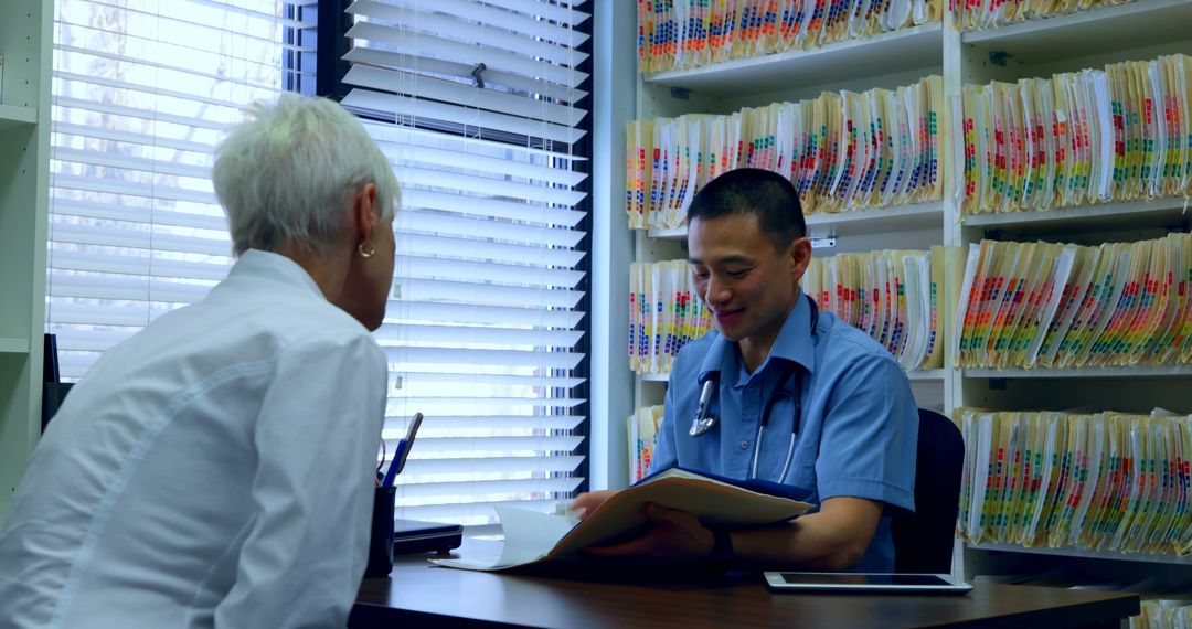 Medical Professional Consulting Elderly Patient in Office with Documents - Free Images, Stock Photos and Pictures on Pikwizard.com