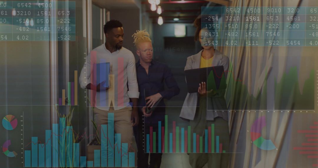 Business Team Walking While Reviewing Data in Office Hallway