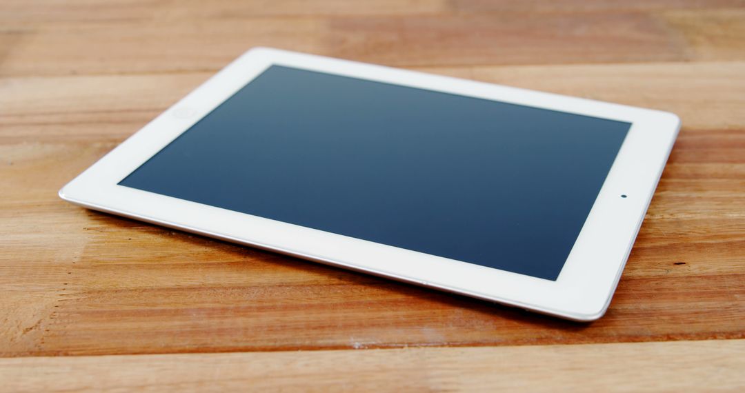 White Tablet Device on Wooden Surface - Free Images, Stock Photos and Pictures on Pikwizard.com