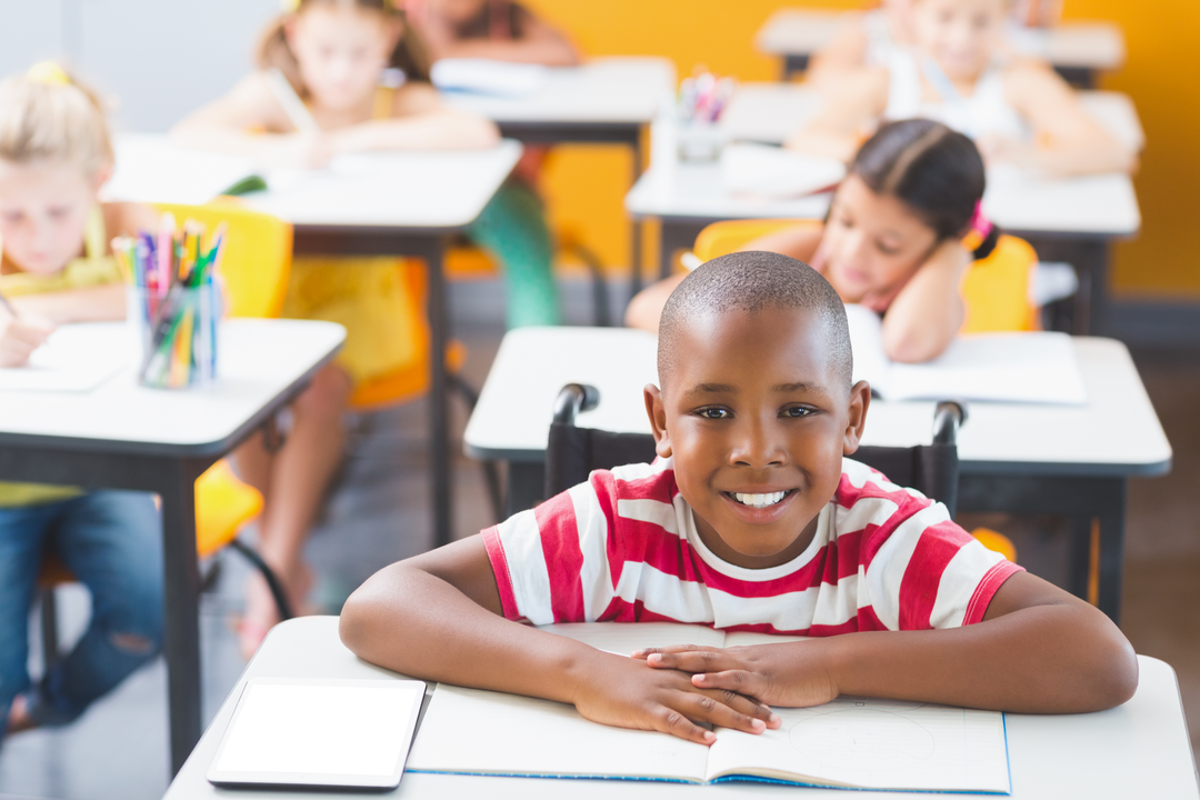 Happy Disabled Schoolboy Smiling in Classroom at School with Transparent Tablet - Download Free Stock Images Pikwizard.com