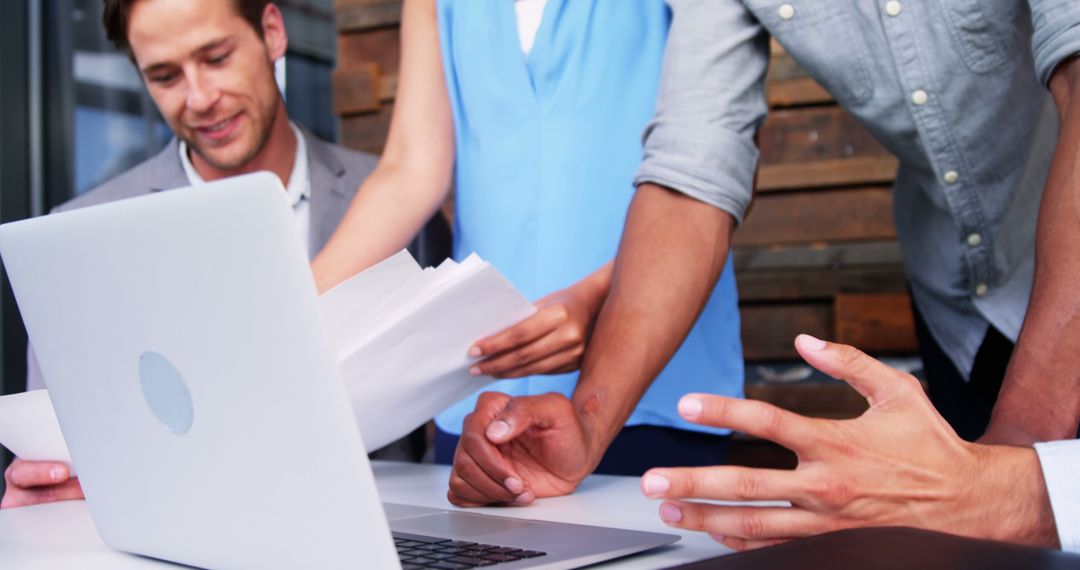 Creative Team Collaborating on Project in Modern Workspace