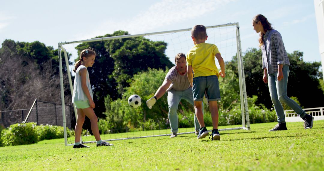 Family Enjoying Outdoor Soccer Game in Backyard on Sunny Day - Free Images, Stock Photos and Pictures on Pikwizard.com