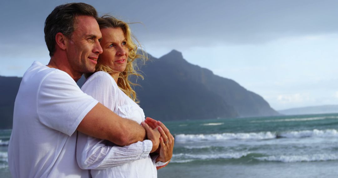 Happy Couple Embracing on a Scenic Beach - Free Images, Stock Photos and Pictures on Pikwizard.com