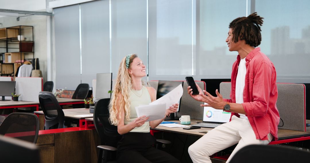 Colleagues Engaging in Office Discussion and Project Planning
