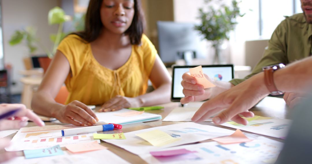 Creative Team Collaborating in Office with Notes and Tablet