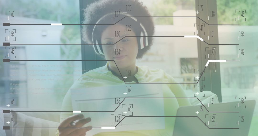 African American Woman at Home Analyzing Digital Data with Technology