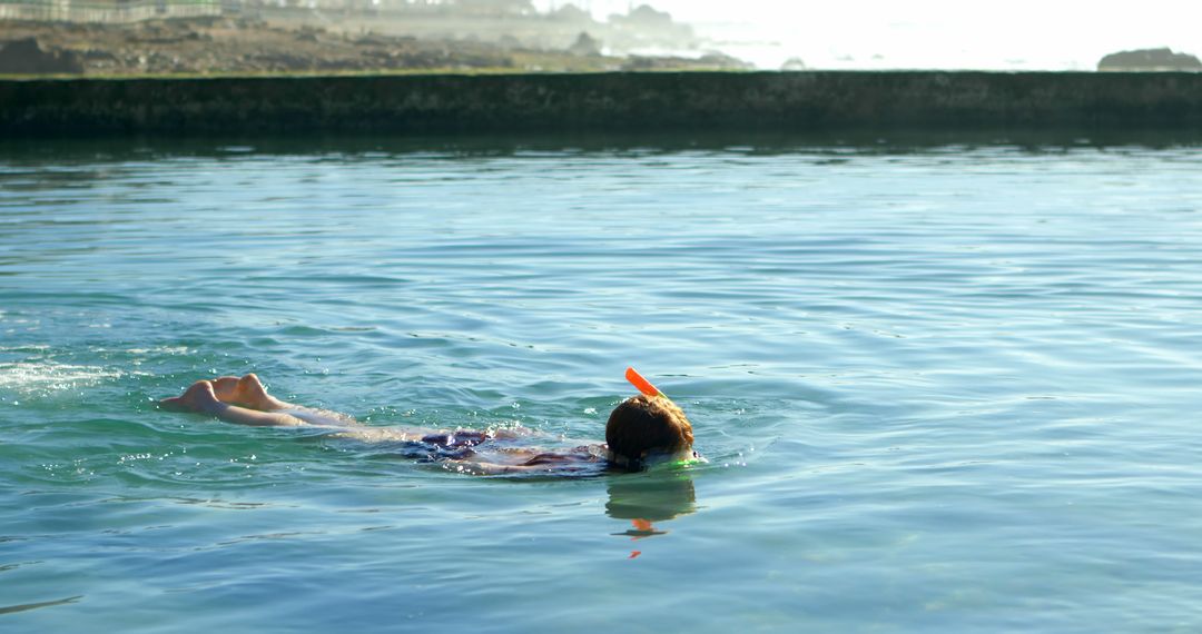 Person Snorkeling in Calm Coastal Lagoon on a Sunny Day - Free Images, Stock Photos and Pictures on Pikwizard.com