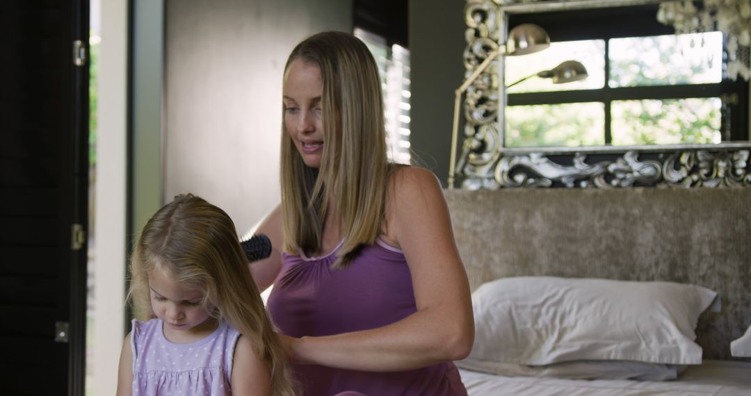 Mother Brushing Daughter's Hair in Modern Bedroom - Free Images, Stock Photos and Pictures on Pikwizard.com