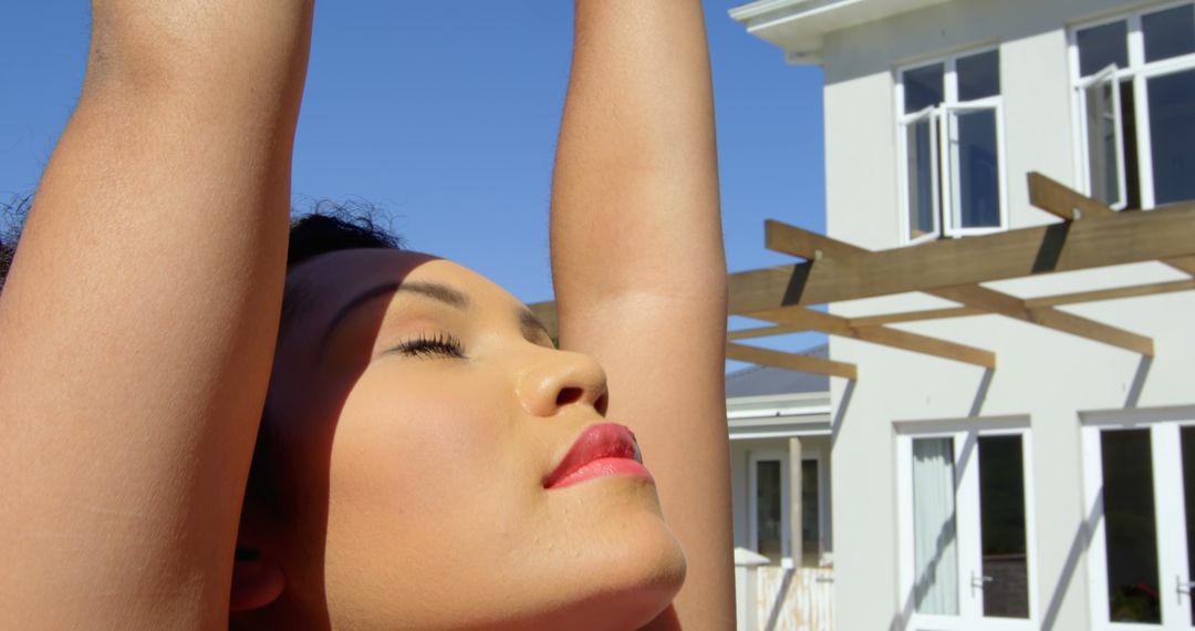 Woman Stretching Outdoors Under Clear Blue Sky - Free Images, Stock Photos and Pictures on Pikwizard.com