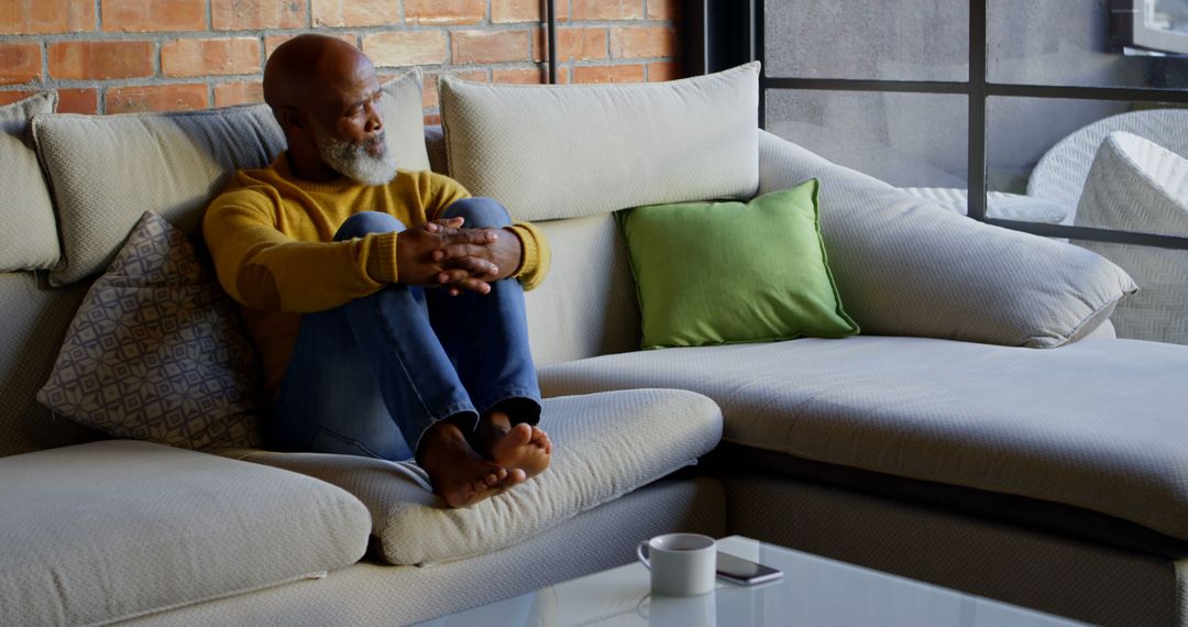 African American Man Relaxing on Cozy Sofa at Home - Free Images, Stock Photos and Pictures on Pikwizard.com