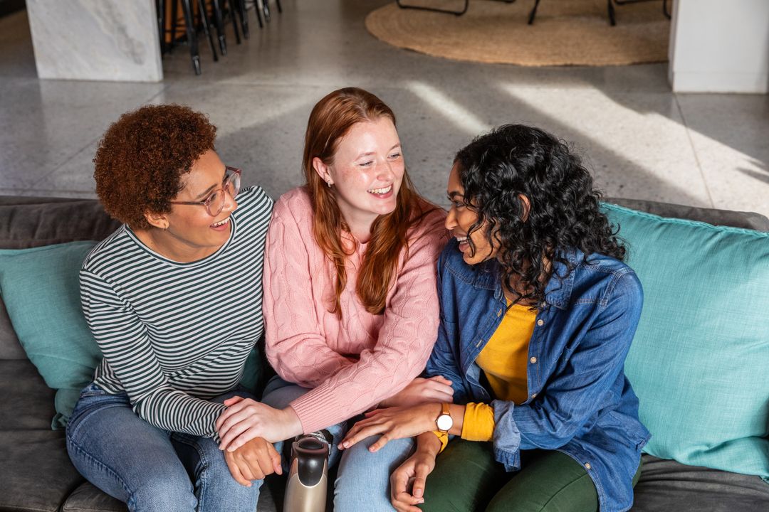 Diverse Friends Laughing Together on Comfortable Couch