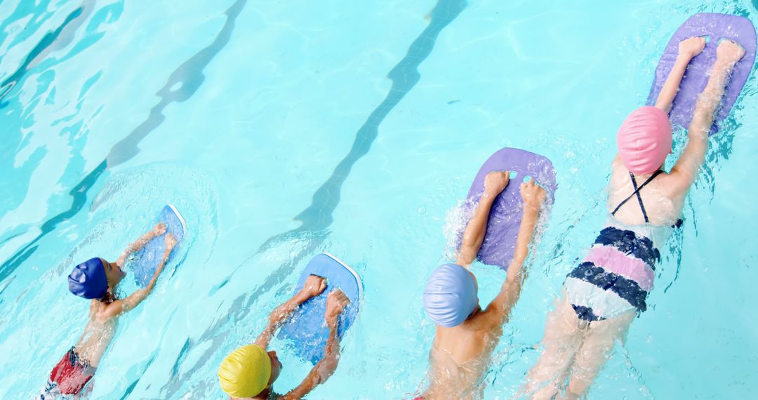 Children Learning to Swim Using Kickboards in Pool