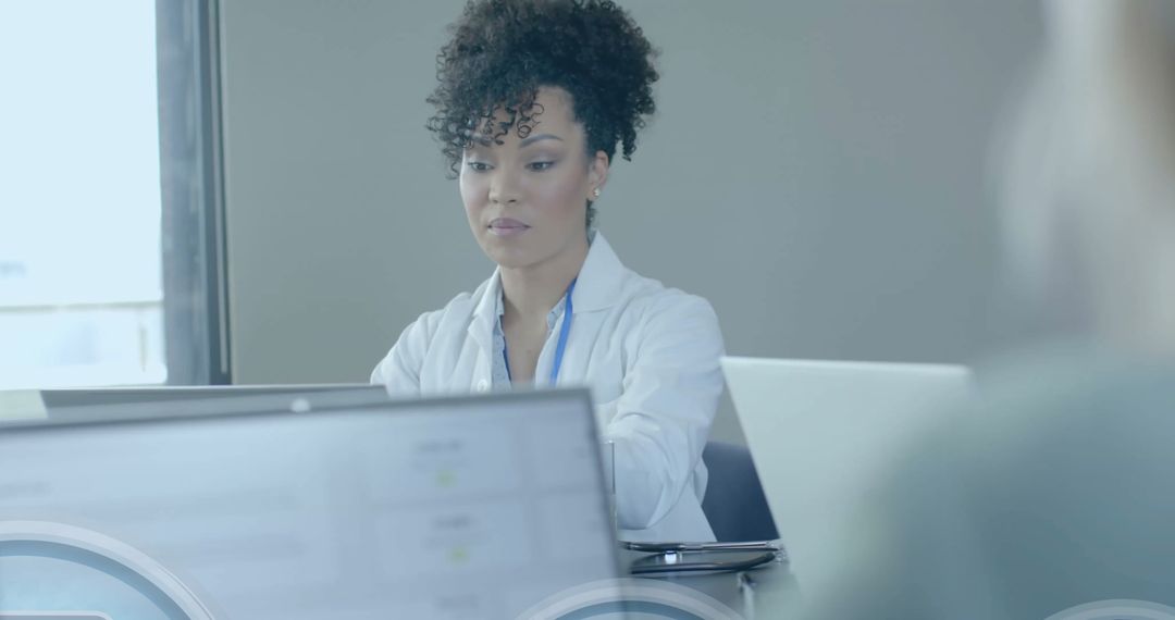 Doctor Analyzing Data on Laptop Secured with Digital Lock