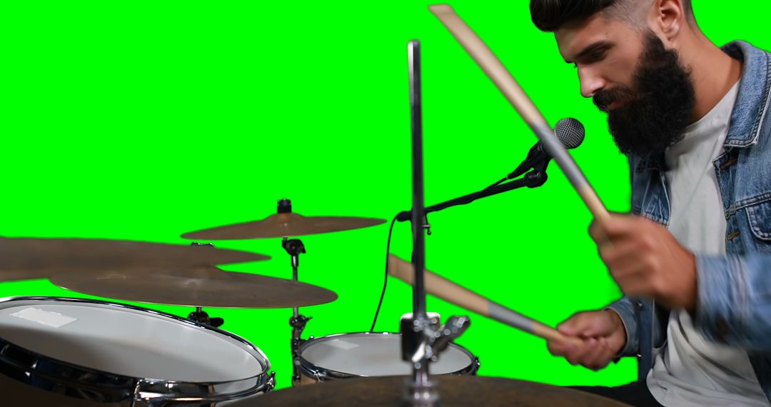 Bearded man playing drums with green screen background - Free Images, Stock Photos and Pictures on Pikwizard.com