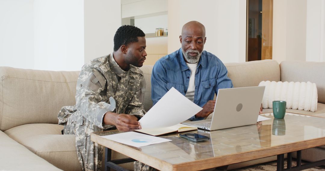 Father and Son Reviewing Documents in Casual Home Environment