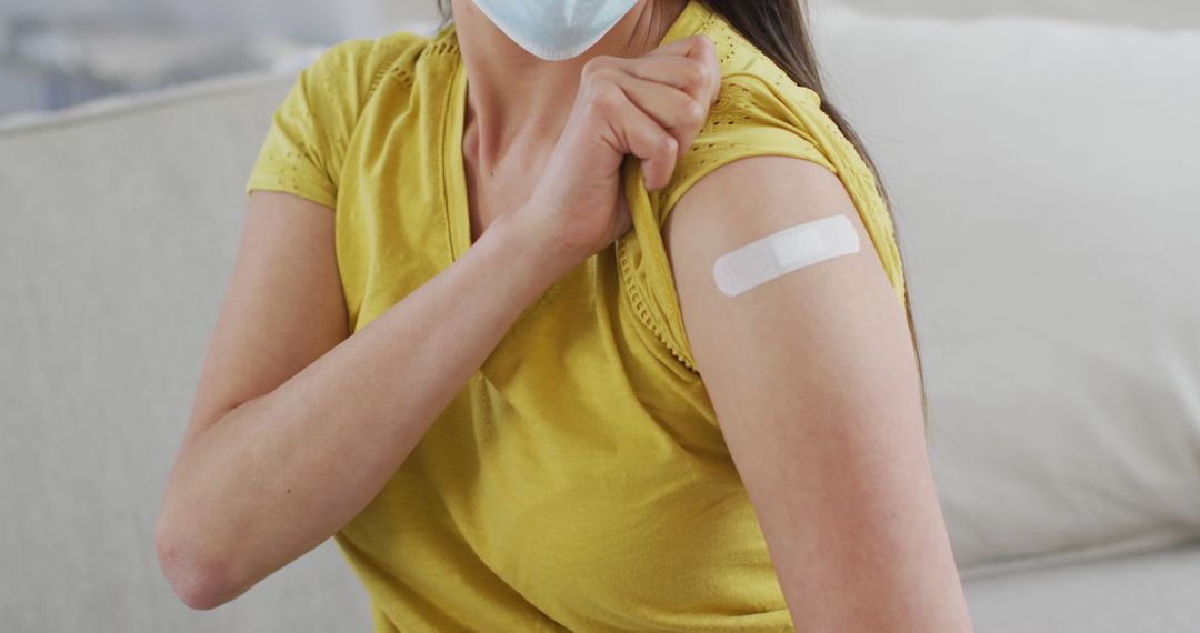 Person Showing Bandage After Vaccination on Arm - Free Images, Stock Photos and Pictures on Pikwizard.com