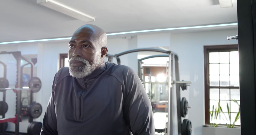 Senior Man Resting in Modern Gym