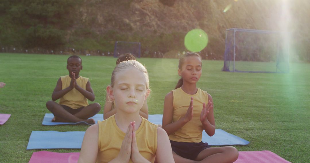 Diverse group of children practicing yoga outdoors at sunset - Free Images, Stock Photos and Pictures on Pikwizard.com