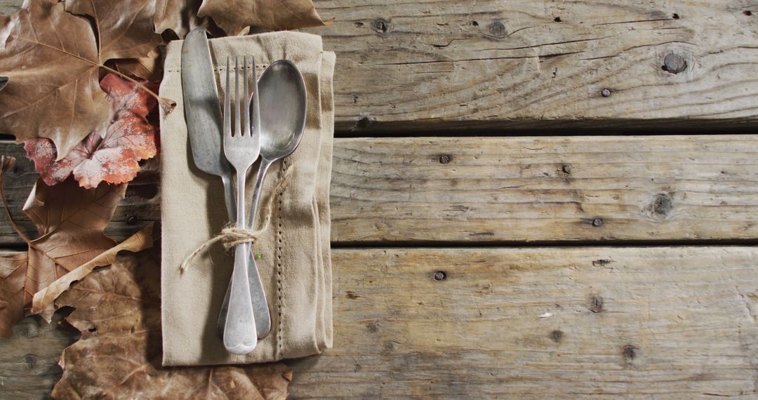 Rustic Table Setting with Autumn Leaves and Wrapped Cutlery - Free Images, Stock Photos and Pictures on Pikwizard.com