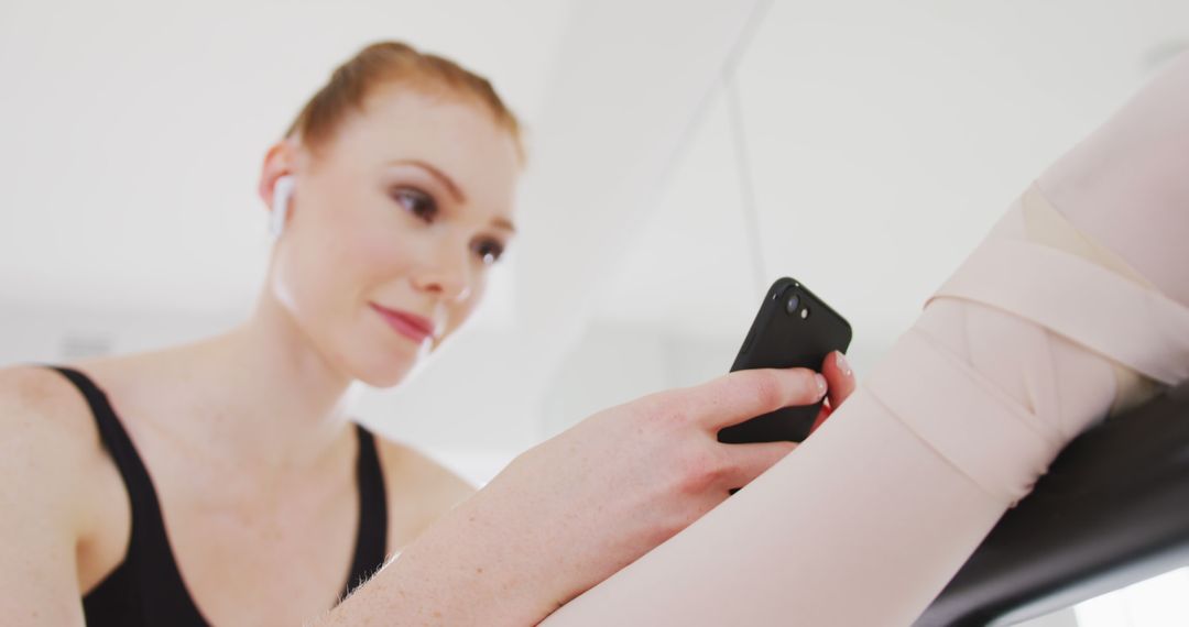 Ballet Dancer Using Smartphone During Break in Studio - Free Images, Stock Photos and Pictures on Pikwizard.com