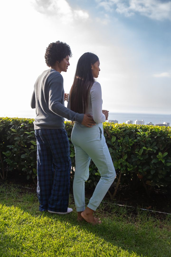 Romantic Couple Enjoying Serene Terrace View Overlooking Ocean
