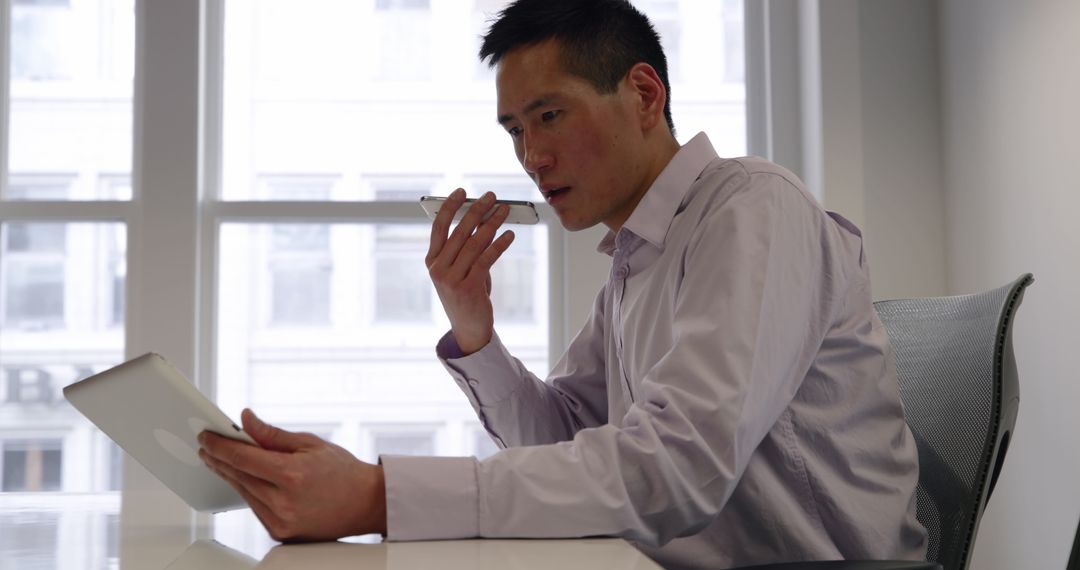 Business Professional Utilizing Technology in Modern Office