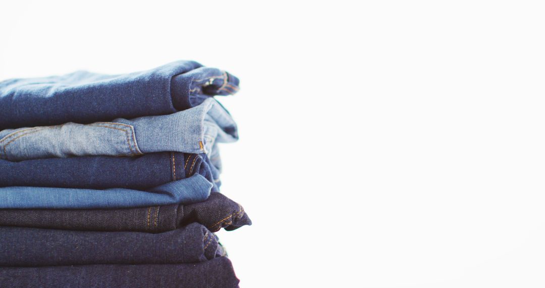 Stack of Folded Denim Jeans on White Background - Free Images, Stock Photos and Pictures on Pikwizard.com