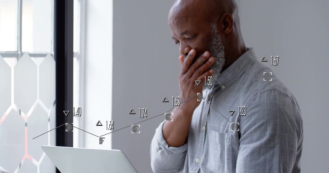 Contemplative Businessman Analyzing Financial Data on Laptop in Modern Office
