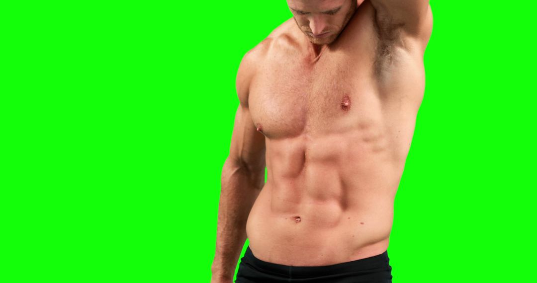 Fit Male with Defined Abs Flexing Against Green Screen - Free Images, Stock Photos and Pictures on Pikwizard.com