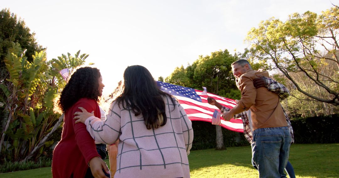 Multiethnic family holding USA flag in park - Free Images, Stock Photos and Pictures on Pikwizard.com