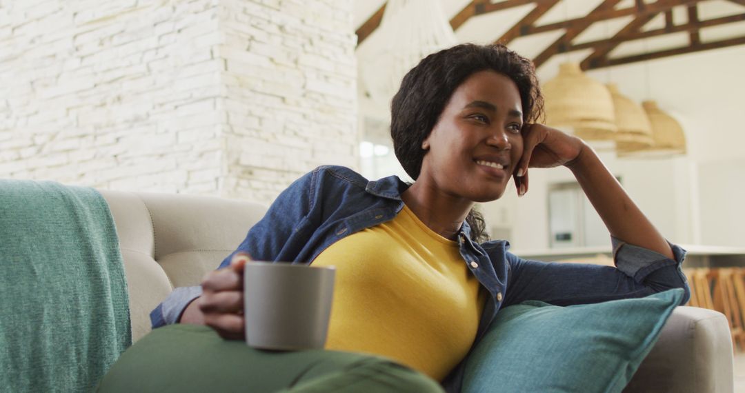 Woman Relaxing at Home with Coffee on a Cozy Sofa - Free Images, Stock Photos and Pictures on Pikwizard.com