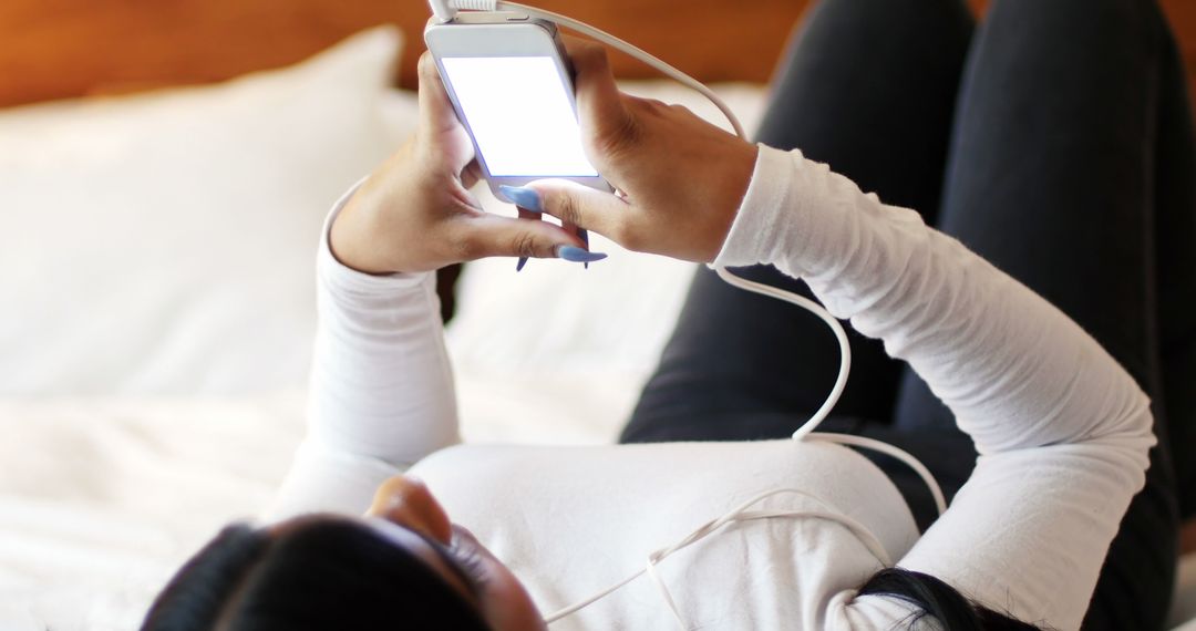 Woman Lying on Bed Using Smartphone - Free Images, Stock Photos and Pictures on Pikwizard.com